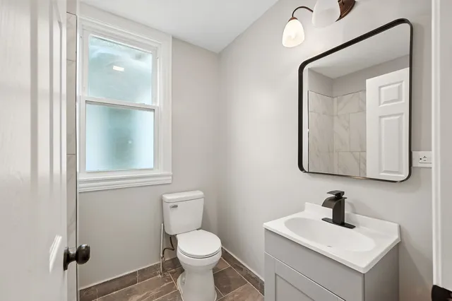 an empty room with wooden floor and window