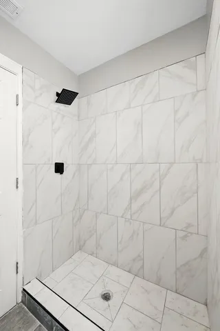 a kitchen with stainless steel appliances granite countertop a stove a sink and white cabinets with wooden floor