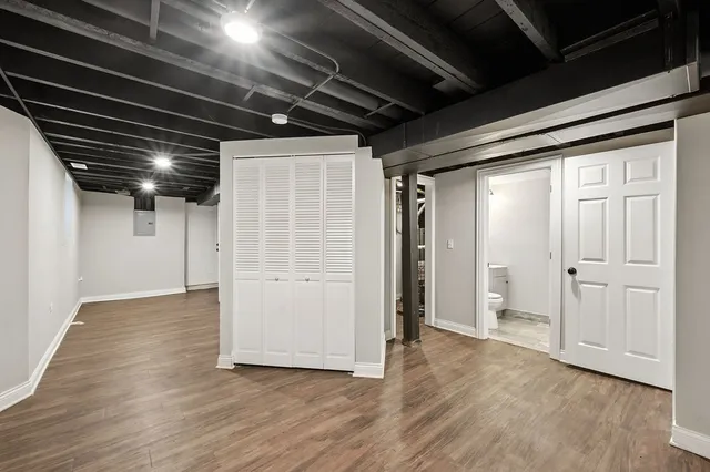 a bathroom with a toilet a sink and mirror