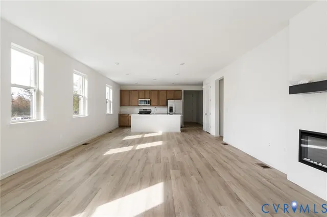 a view of a living room with furniture and flat screen tv