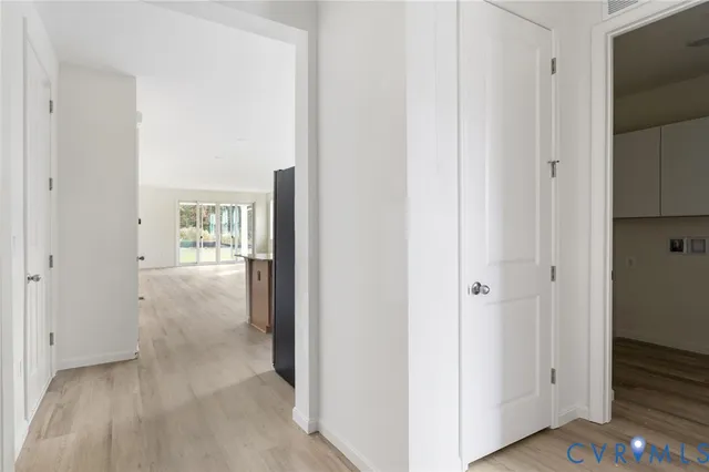 a view of a hallway with wooden floor