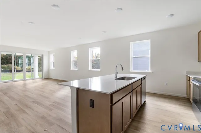a kitchen with a sink stove and cabinets