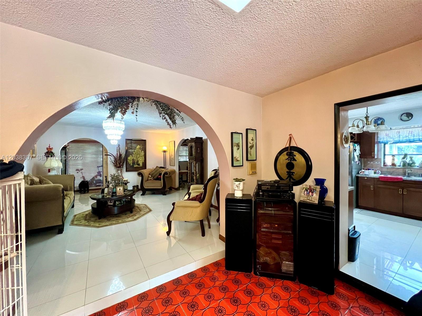 9601 Southwest 66th Street Miami, FL 33173 - Photo 15 of 62 a living room with furniture a mirror and a large window