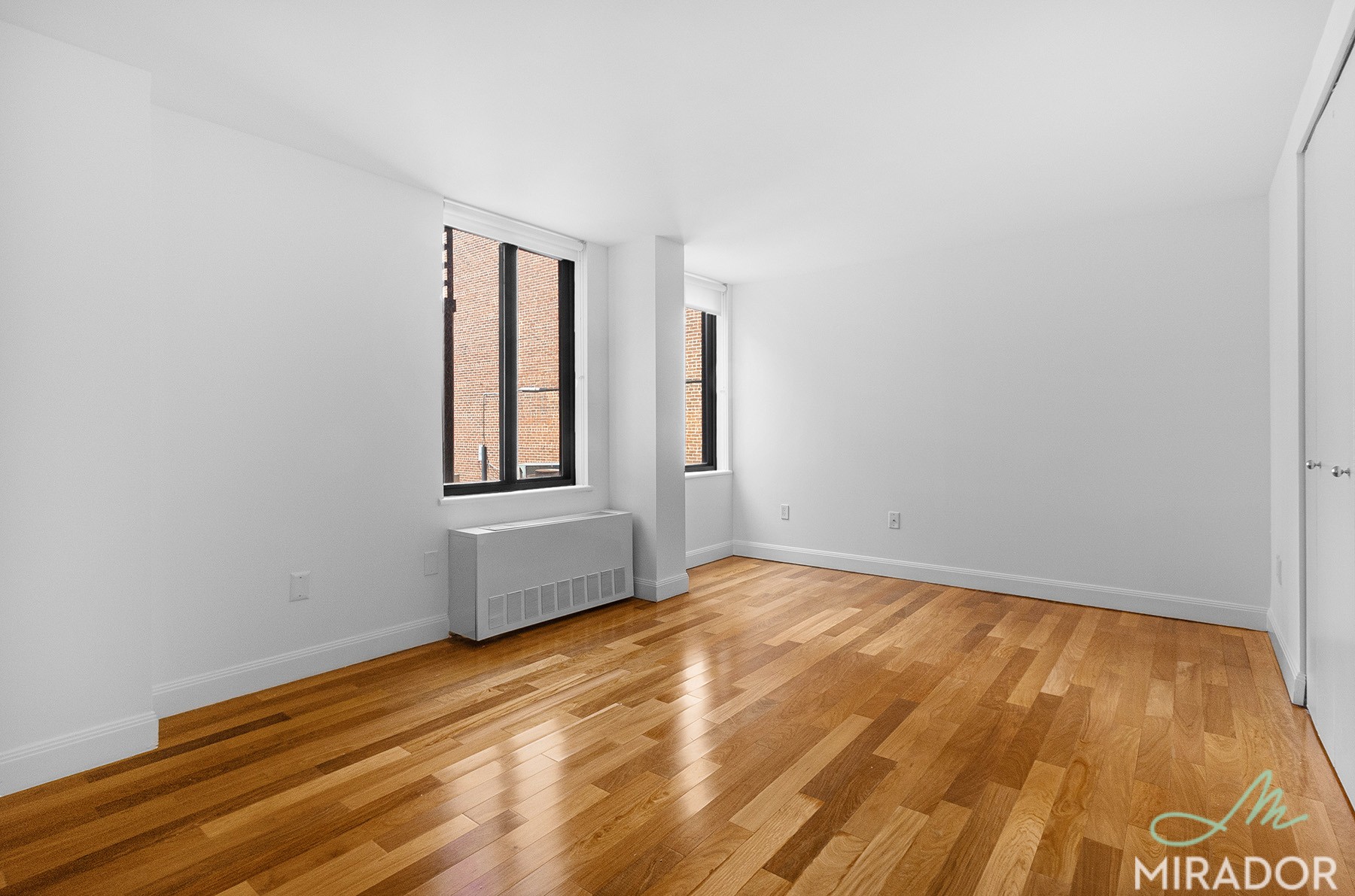 290 3rd Avenue, Unit 4C Manhattan, NY 10010 - Photo 12 of 27 a view of an empty room with wooden floor and a window