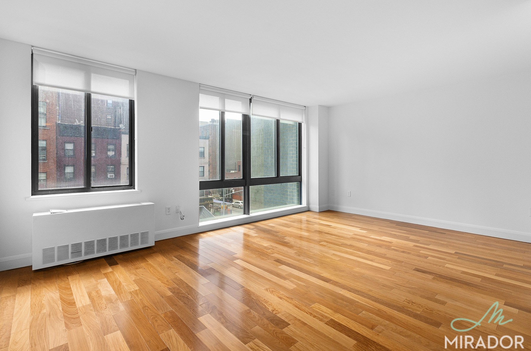 290 3rd Avenue, Unit 4C Manhattan, NY 10010 - Photo 3 of 27 a view of an empty room with wooden floor and a window