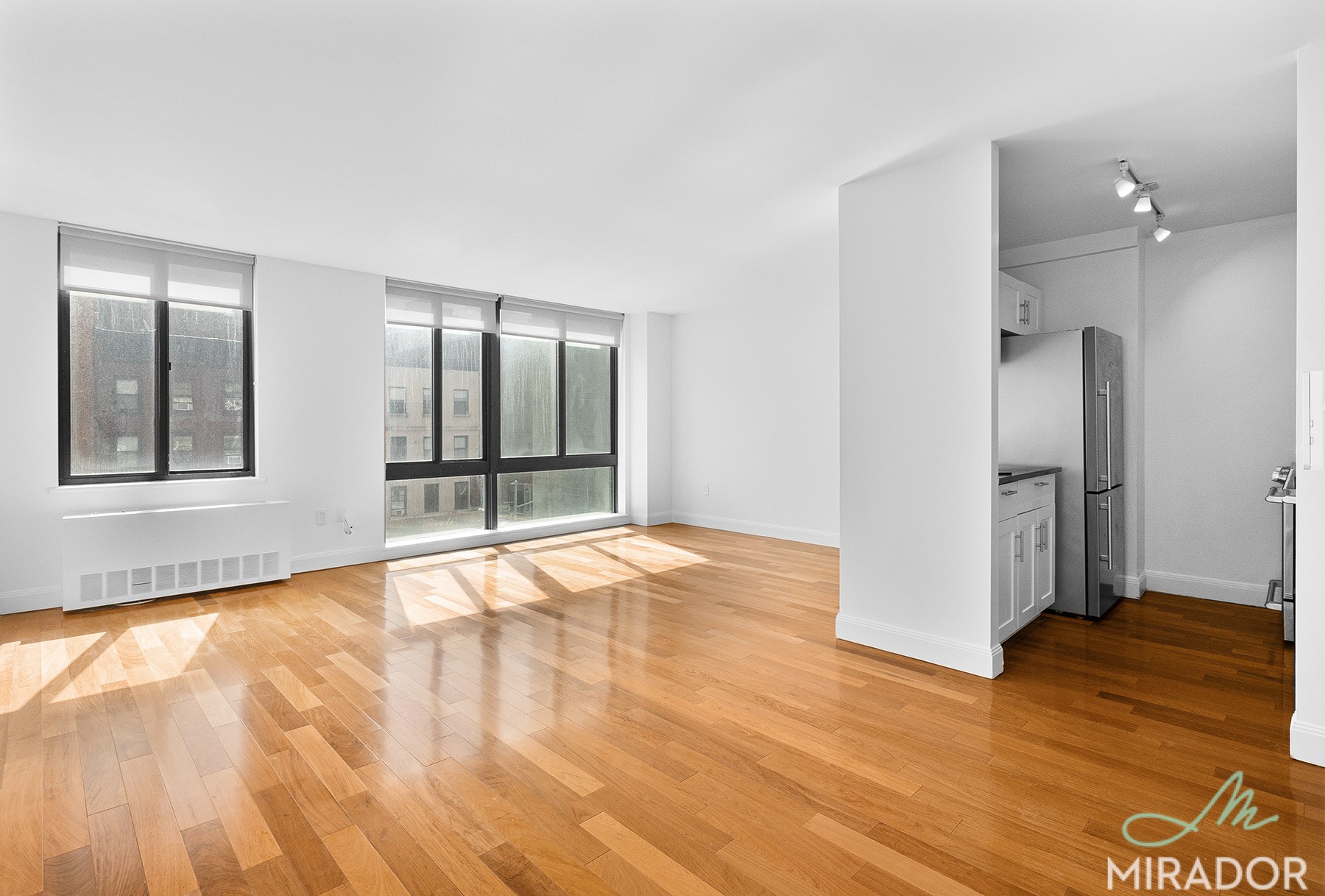 290 3rd Avenue, Unit 4C Manhattan, NY 10010 - Photo 5 of 27 a view of an empty room with wooden floor and a window