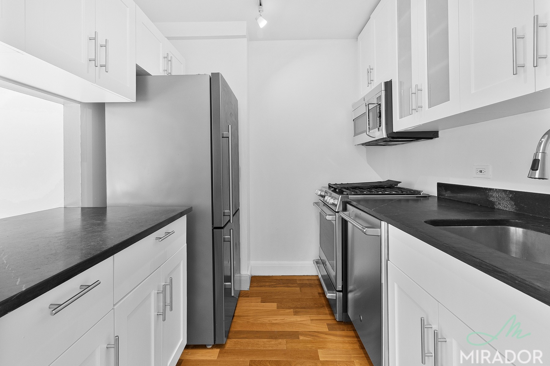 290 3rd Avenue, Unit 4C Manhattan, NY 10010 - Photo 6 of 27 a kitchen with stainless steel appliances granite countertop a sink and a refrigerator