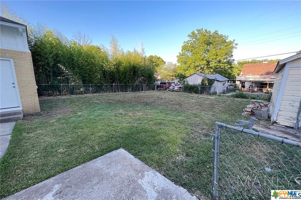 809 North 8th Street Temple, TX 76501 - Photo 17 of 20 A spacious, fenced backyard offers ample room for outdoor activities and potential landscaping.