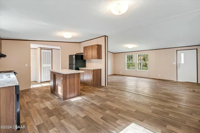 a kitchen with granite countertop a stove a sink and a microwave