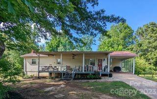 180 Sunset Drive Rutherfordton, NC 28139 - Photo 1 of 44 a front view of a house with garden