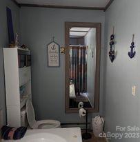 180 Sunset Drive Rutherfordton, NC 28139 - Photo 12 of 44 a bathroom with a sink and a mirror