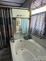 180 Sunset Drive Rutherfordton, NC 28139 - Photo 14 of 44 a bathroom with a bathtub and shower