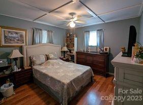 180 Sunset Drive Rutherfordton, NC 28139 - Photo 17 of 44 a bedroom with a large bed a chandelier and dresser