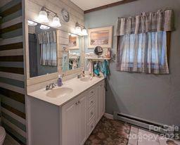 180 Sunset Drive Rutherfordton, NC 28139 - Photo 21 of 44 a bathroom with a double vanity sink and a mirror