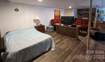 180 Sunset Drive Rutherfordton, NC 28139 - Photo 27 of 44 a bedroom with a bed a window and glass door