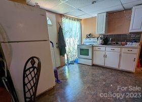 180 Sunset Drive Rutherfordton, NC 28139 - Photo 28 of 44 a kitchen with granite countertop a refrigerator a sink a stove and a refrigerator