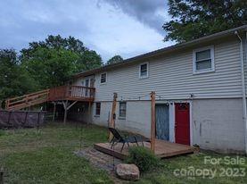 180 Sunset Drive Rutherfordton, NC 28139 - Photo 33 of 44 a view of backyard with seating space and wooden fence