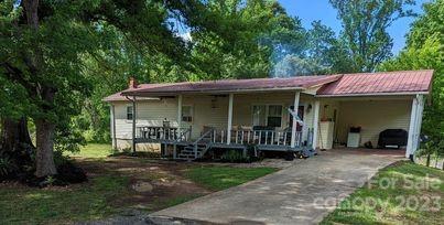 180 Sunset Drive Rutherfordton, NC 28139 - Photo 37 of 44 a view of a chair and table in front of house