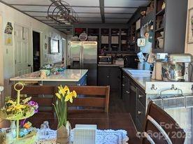 180 Sunset Drive Rutherfordton, NC 28139 - Photo 8 of 44 a kitchen with a table and chairs in it