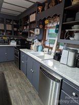 180 Sunset Drive Rutherfordton, NC 28139 - Photo 9 of 44 a kitchen with stainless steel appliances granite countertop a sink a stove and a counter top space