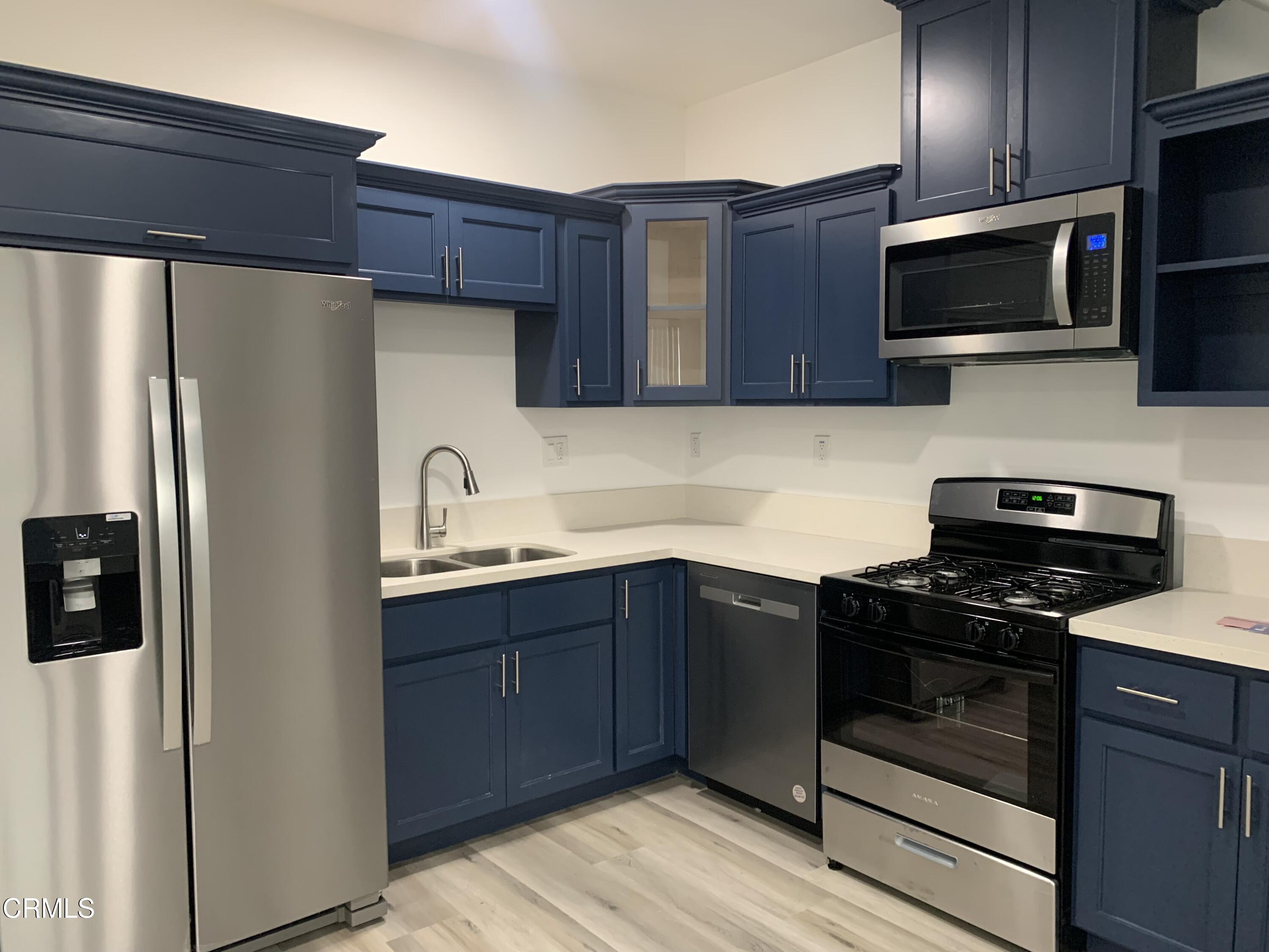 6375 Converse Avenue, Unit A Los Angeles, CA 90001 - Photo 3 of 14 a kitchen with stainless steel appliances granite countertop a refrigerator stove a sink dishwasher and microwave oven