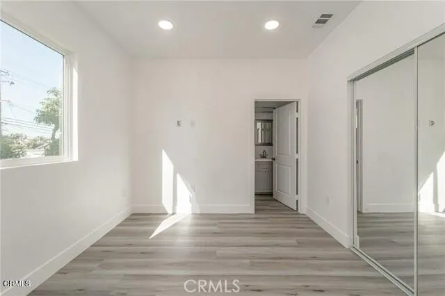 a view of a room with wooden floor and window