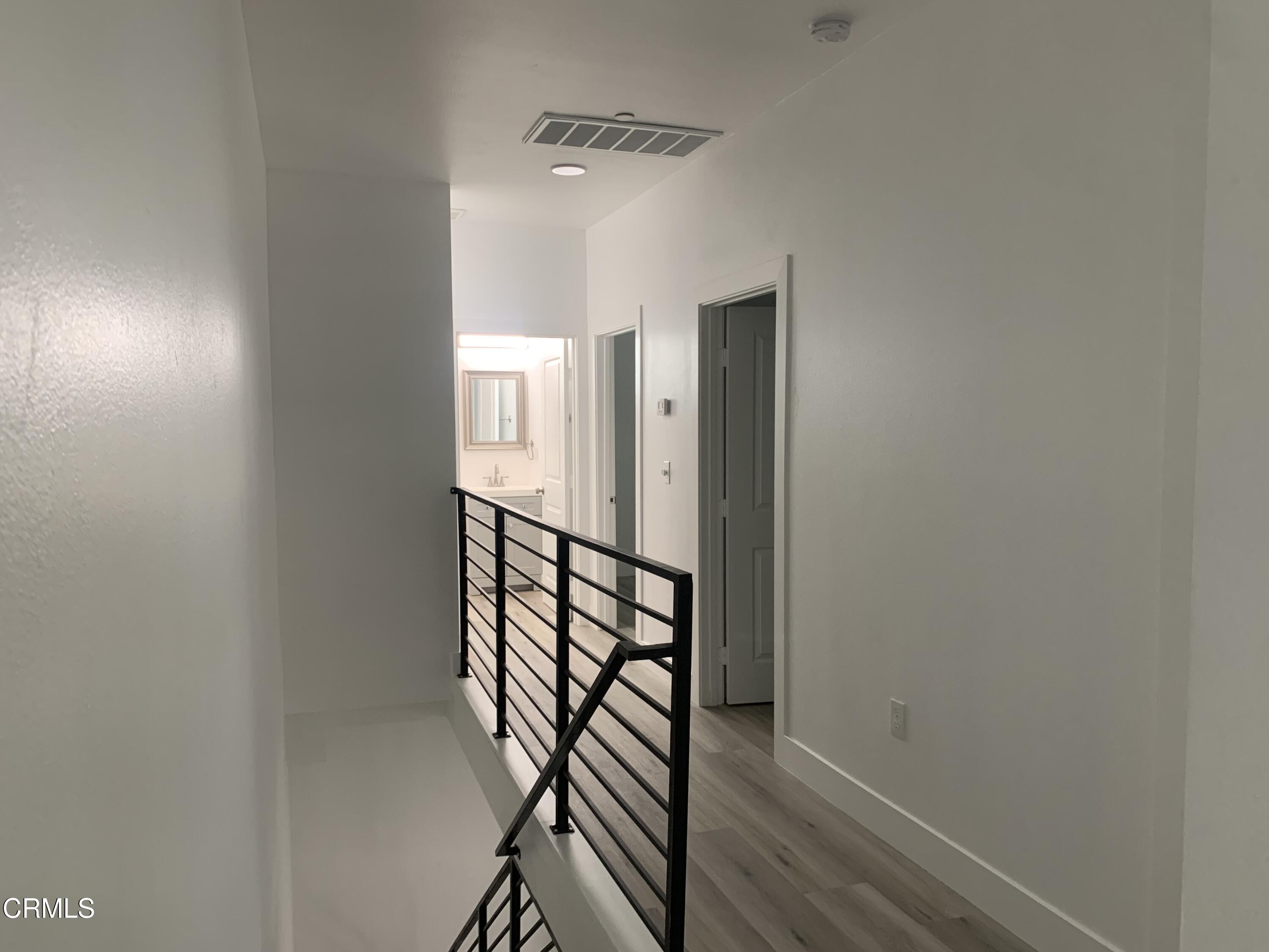 6375 Converse Avenue, Unit A Los Angeles, CA 90001 - Photo 6 of 14 a view of a hallway with wooden floor and staircase