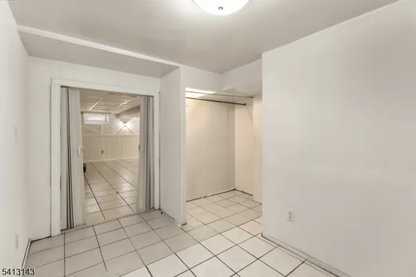 a view of a park with snow on the road