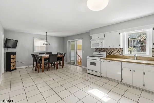 a kitchen with stainless steel appliances a sink counter space and a window