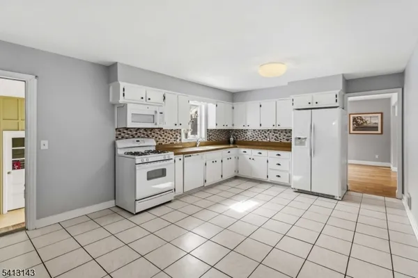 a kitchen with stainless steel appliances a refrigerator sink and cabinets