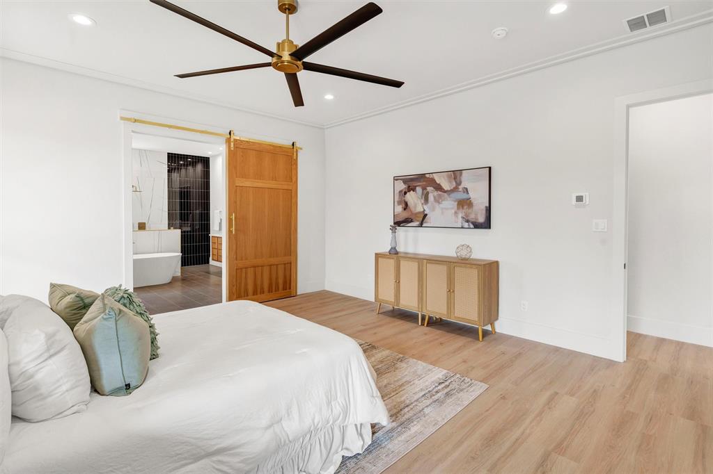 428 Squaw Creek Road Willow Park, TX 76087 - Photo 24 of 34 a bedroom with a bed and a wooden floor