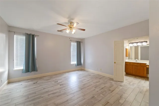 a view of an empty room with a kitchen
