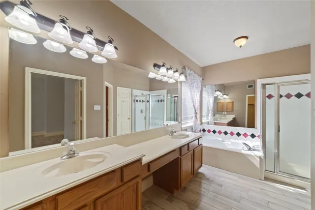 a large bathroom with a sink mirror and a bath tub