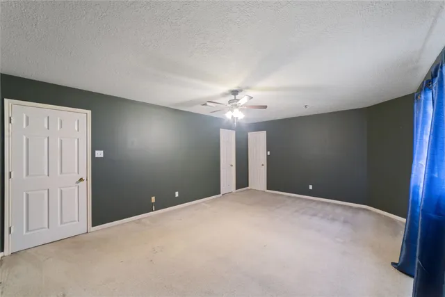 a view of an outdoor sitting area with couch and umbrella