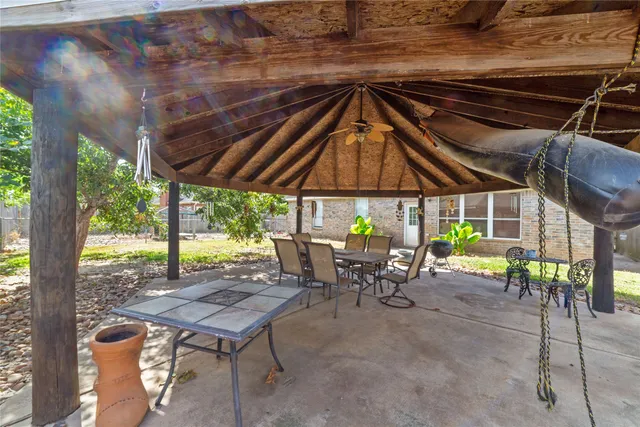 a view of house with backyard and trees