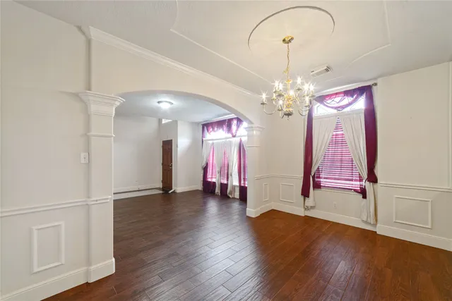 a view of a room with wooden floor and window