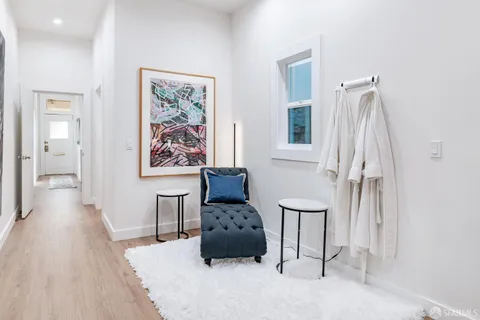 a living room with furniture and a painting on the wall