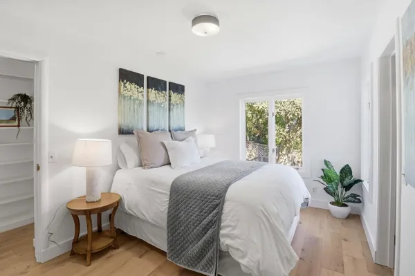 a bedroom with a bed and a potted plant