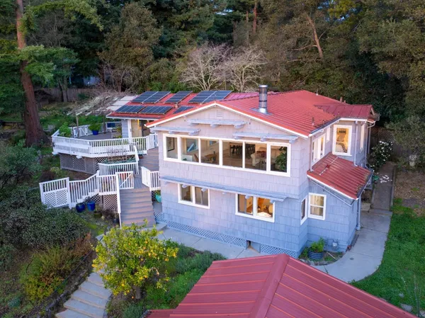 an aerial view of a house with a yard