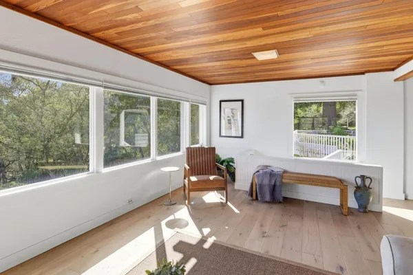a bedroom with furniture and a large window