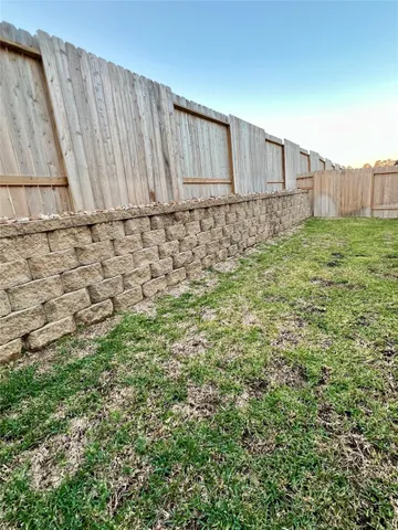 a view of a backyard with wooden fence