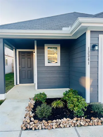 a front view of a house with a yard and flowers