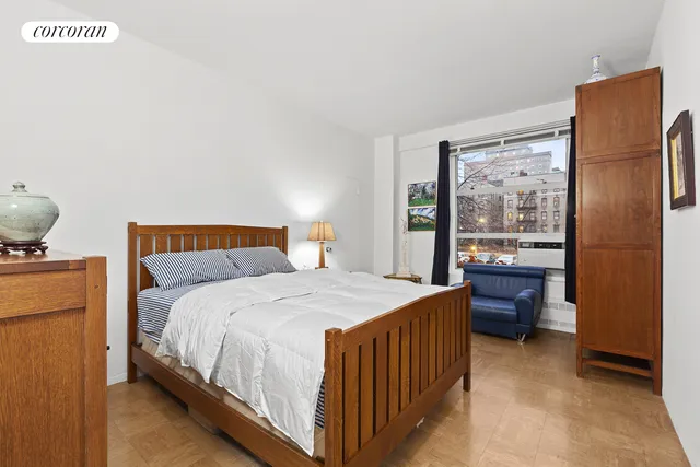 a bedroom with a bed and a dresser