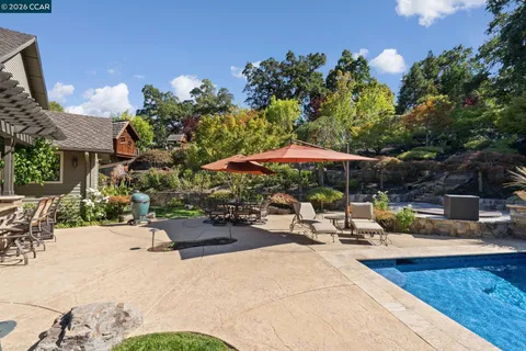 a view of a backyard with sitting area and furniture