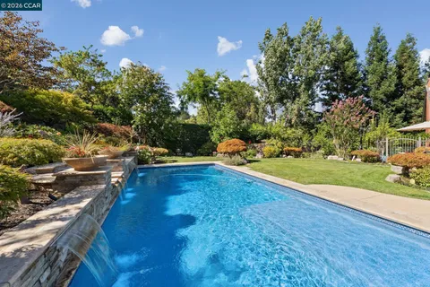 a view of a yard with swimming pool