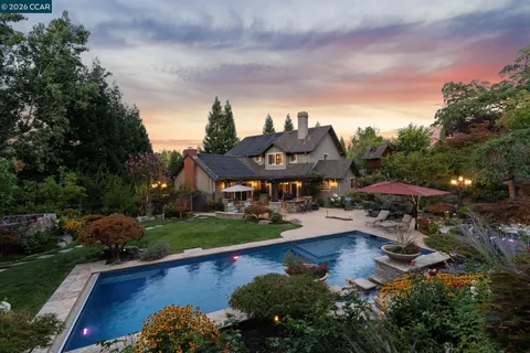 an aerial view of a house with garden space lake view and mountain view