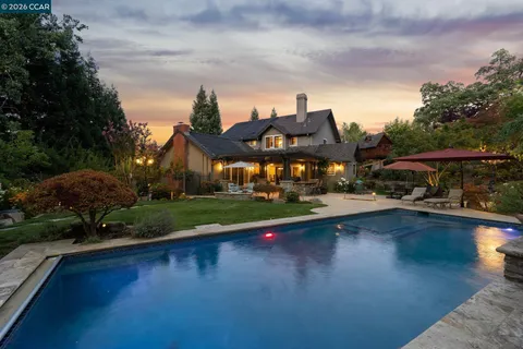 a front view of a house with swimming pool having outdoor seating