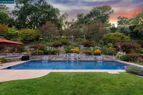 a view of an house with swimming pool and yard