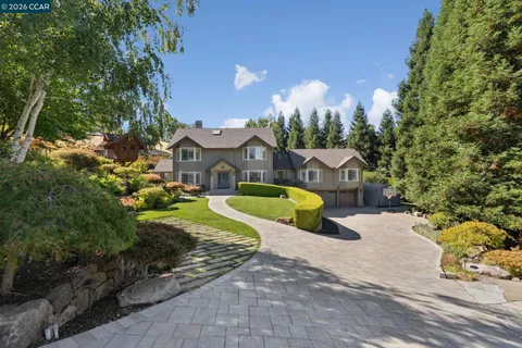 a view of a house with a yard and pathway