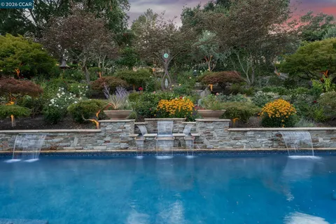 a view of a patio with chairs and potted plants